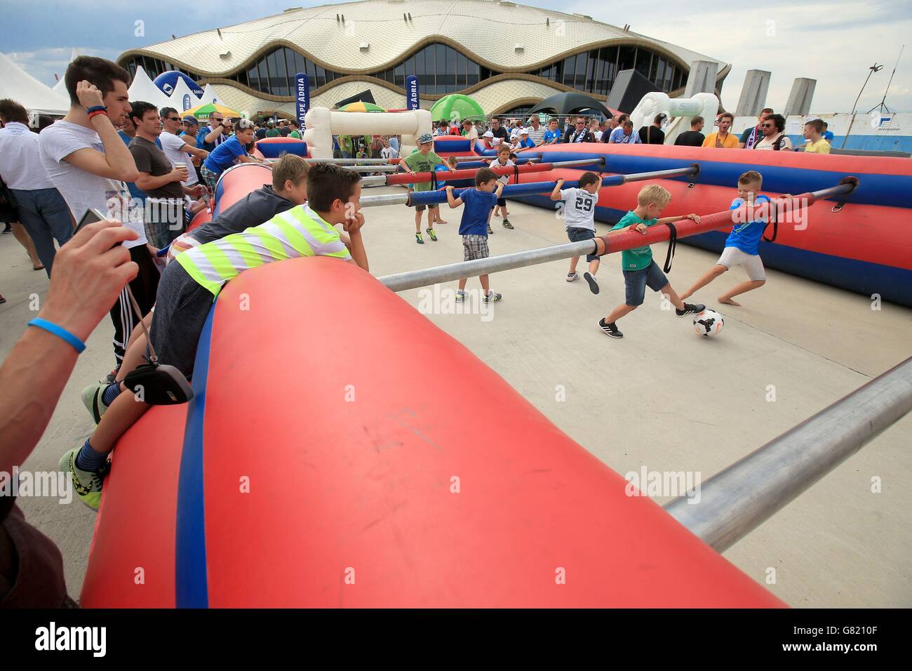 Young football fans play in a life size table football pitch before the