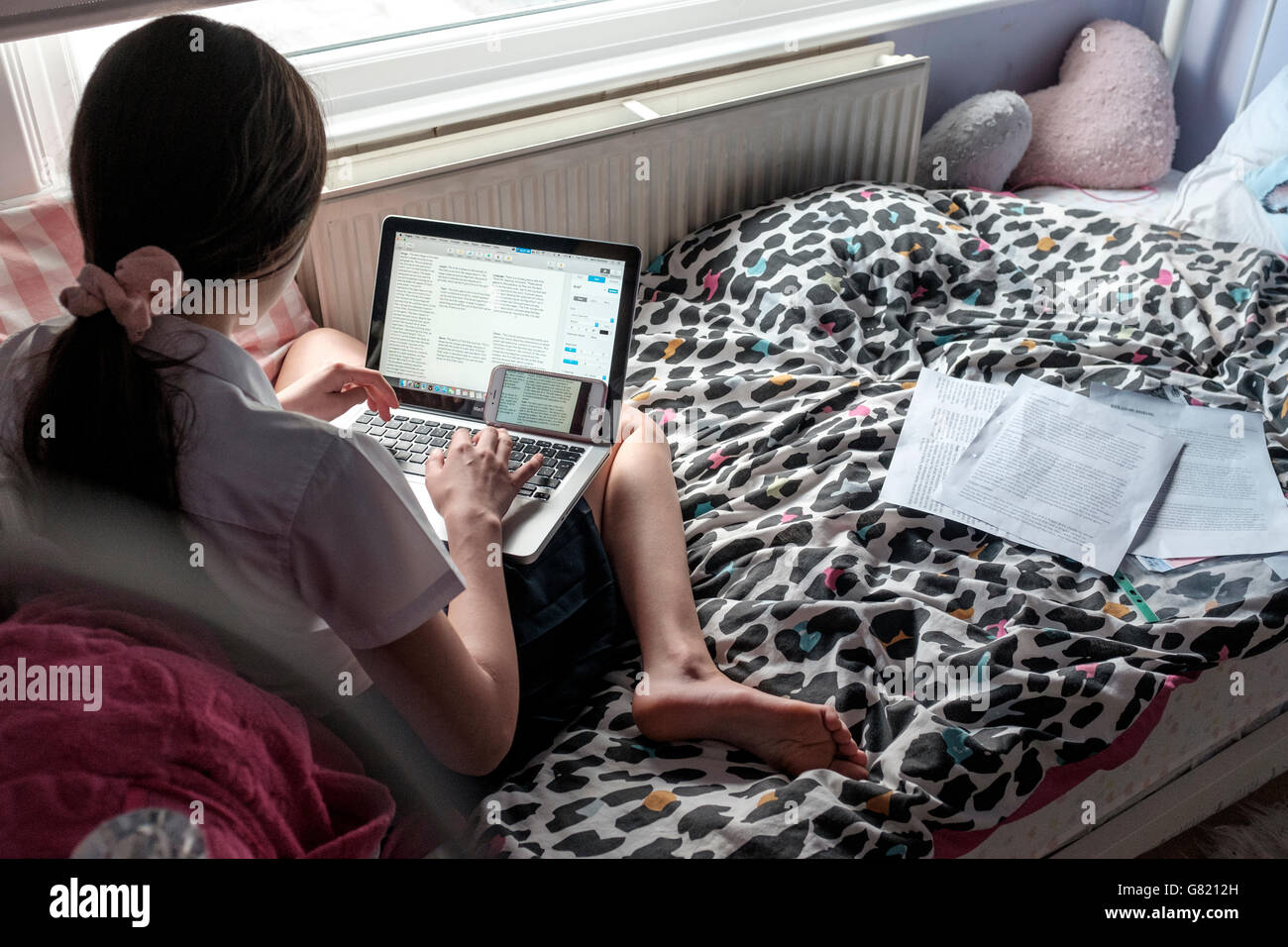 Teenage schoolgirl working on laptop in her bedroom,UK Stock Photo - Alamy