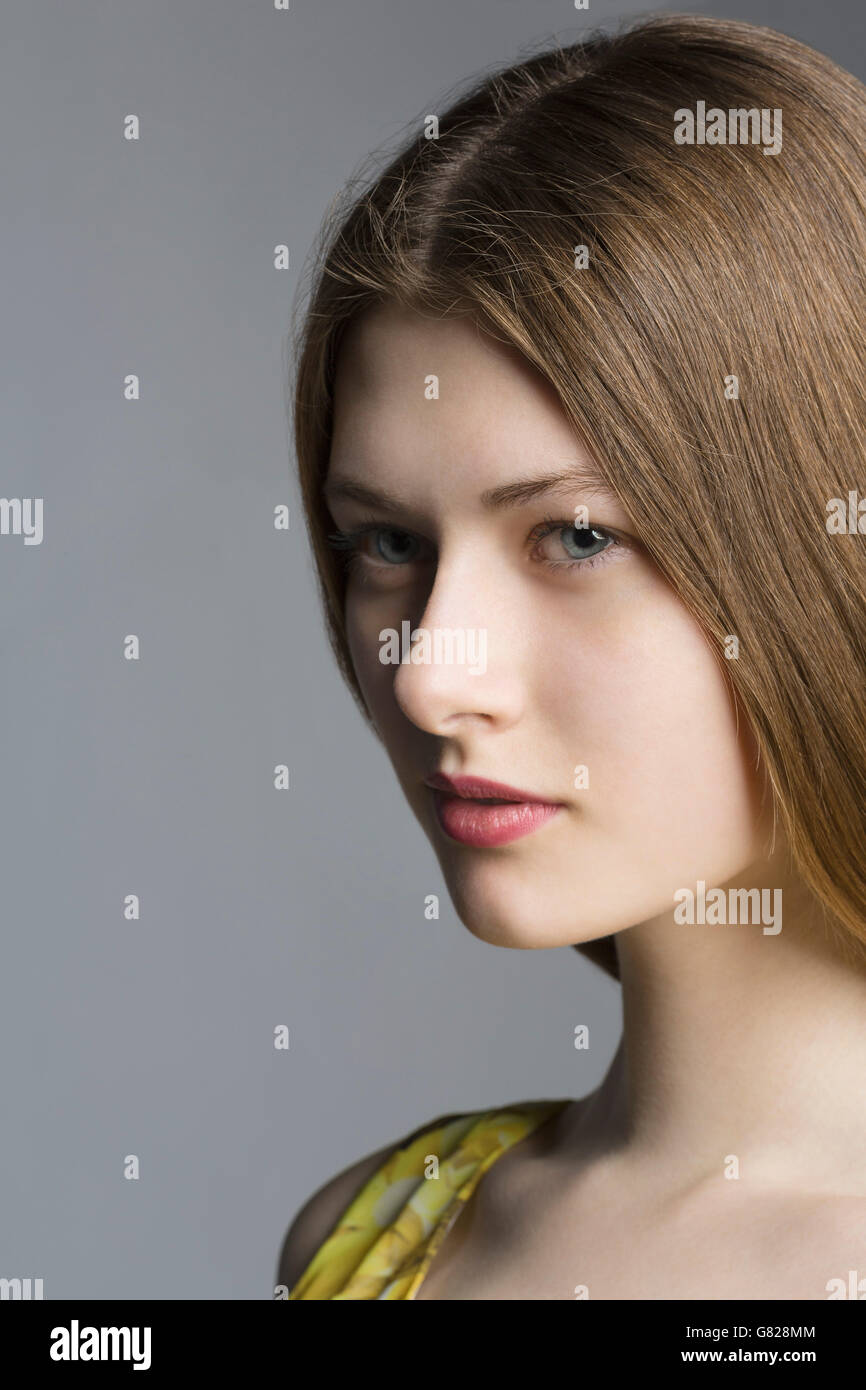 Portrait of beautiful woman against gray background Stock Photo - Alamy