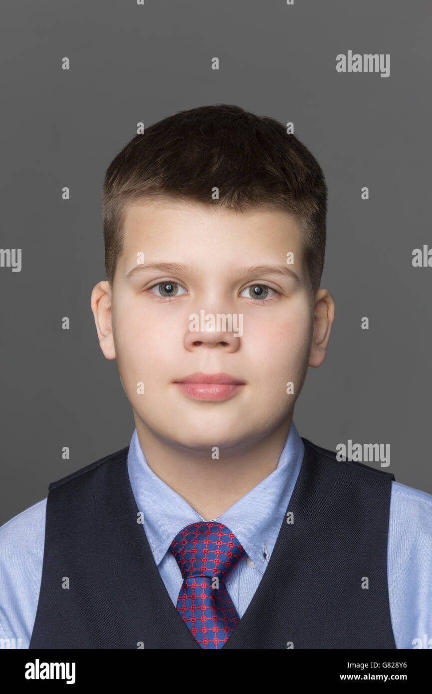 Portrait of boy against gray background Stock Photo