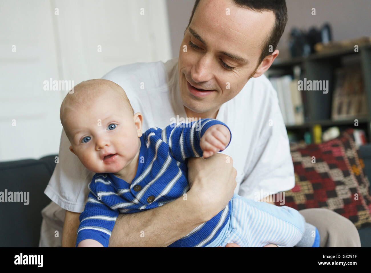 Close-up of father playing with son at home Stock Photo