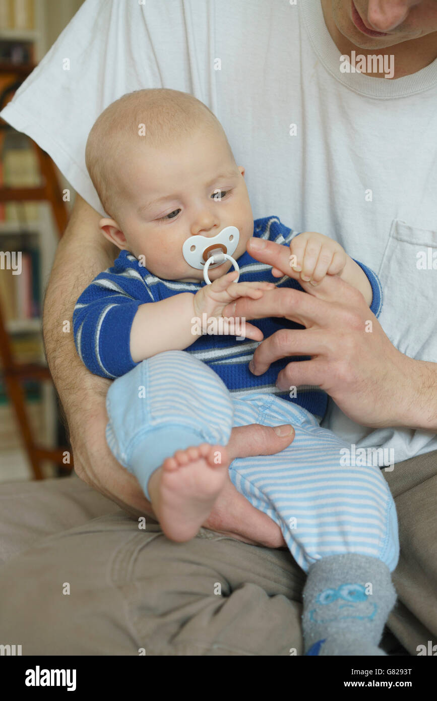 Midsection of father playing with son at home Stock Photo
