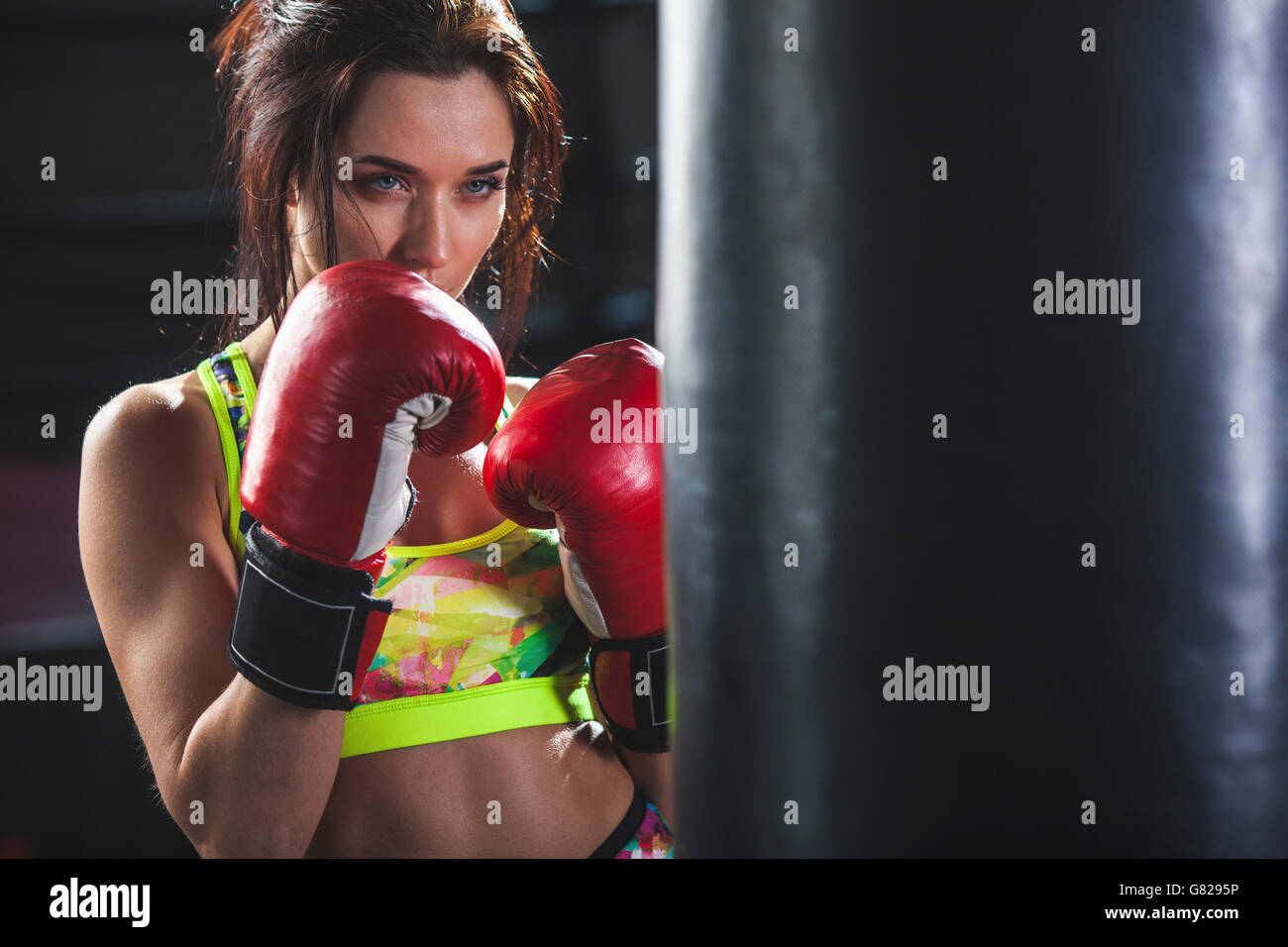 Young woman hitting punching bag Stock Photo Alamy