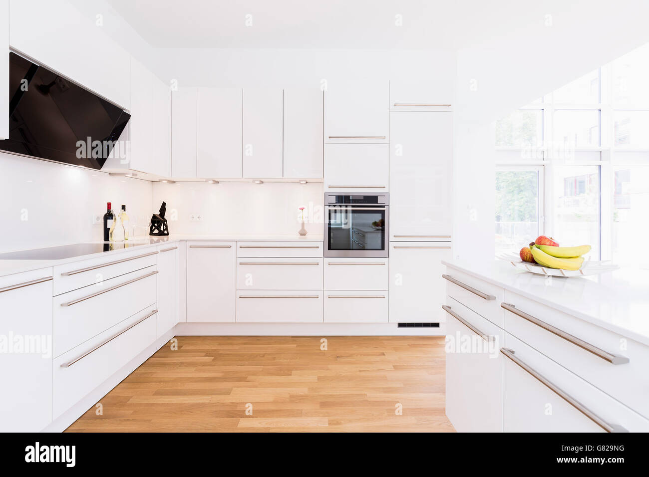 Modern kitchen design with white cabinets Stock Photo - Alamy
