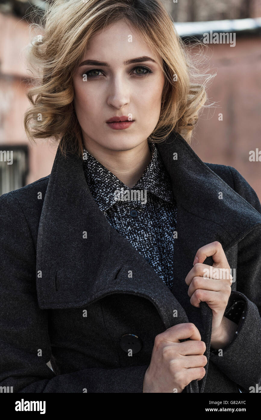Woman in long black coat hi-res stock photography and images - Alamy