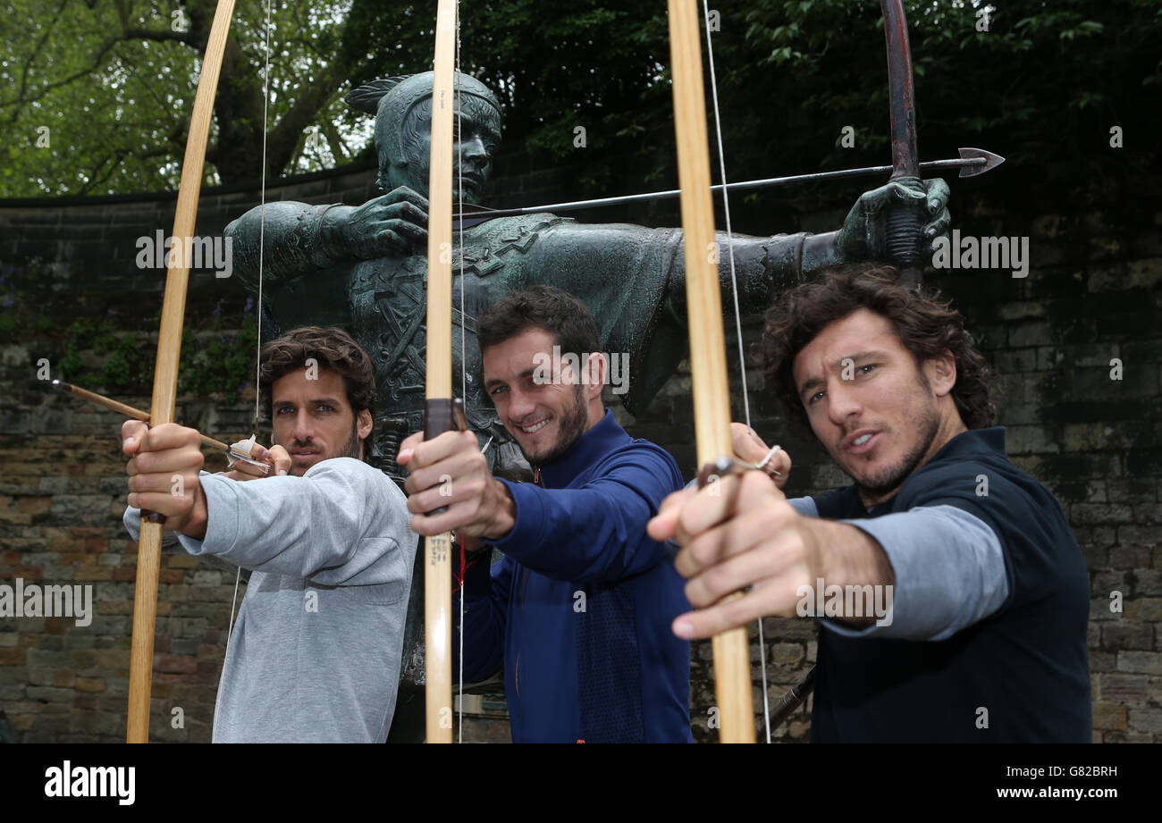 Spain's Feliciano Lopez (left), Great Britain's James Ward (centre) and Argentina's Juan Monaco pose for a photograph next to the city's Robin Hood statue during a photocall at Nottingham Castle, Nottingham. Stock Photo