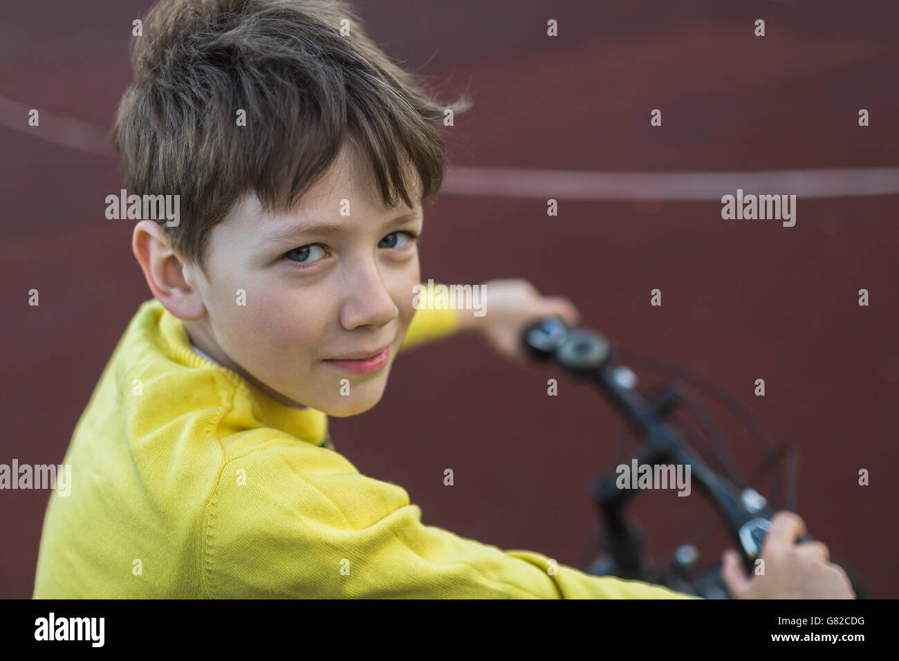 Portrait of smiling boy cycling outdoors Stock Photo