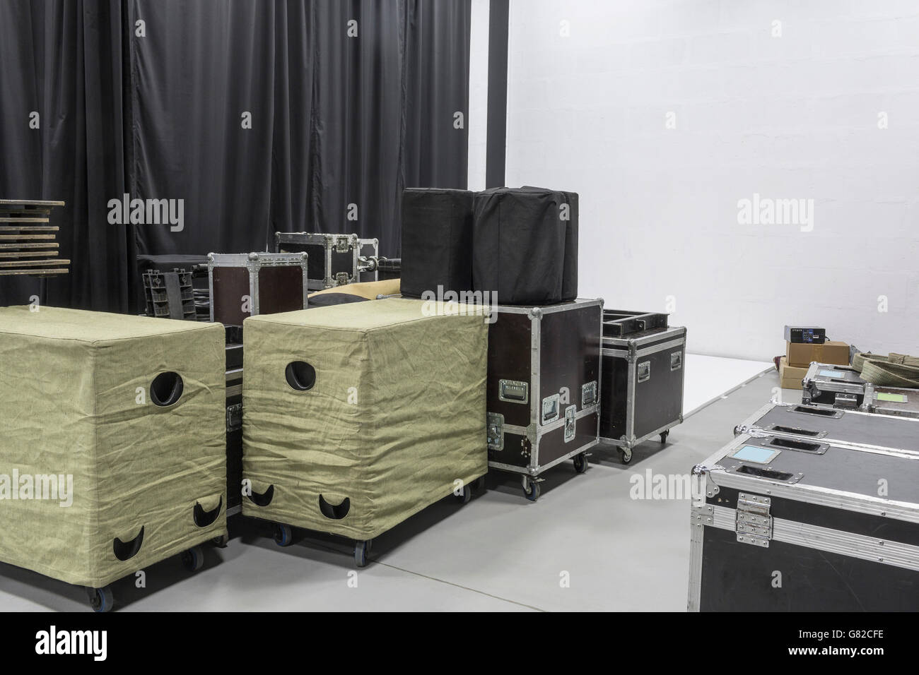 Audio equipment boxes by curtains in studio Stock Photo Alamy