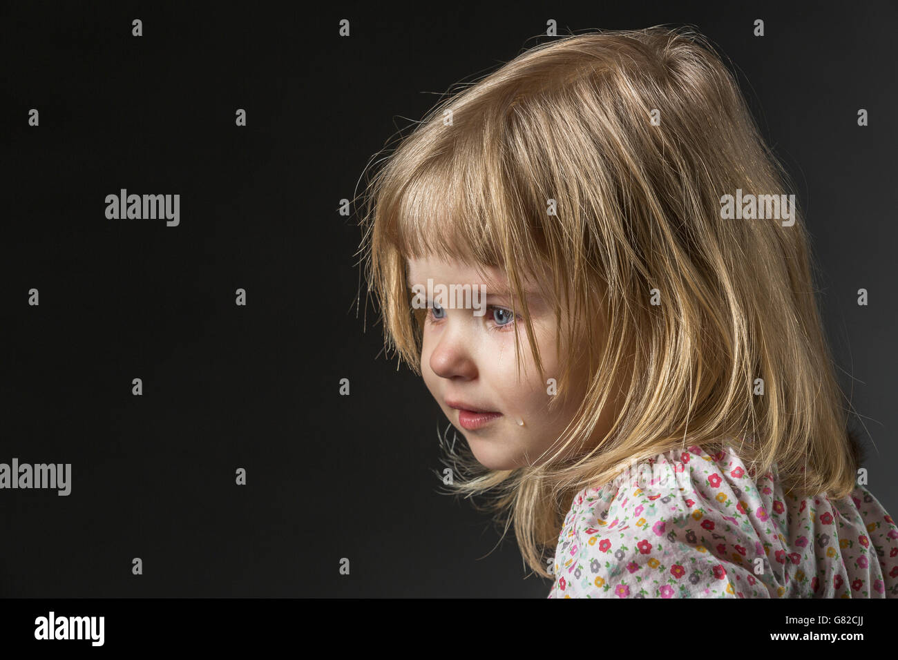 sad woman crying, looking aside on black background, closeup portrait,  profile view Stock Photo - Alamy