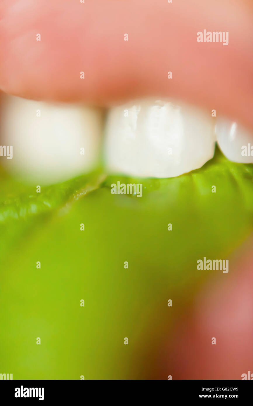 Extreme close-up of woman eating leafy vegetable Stock Photo
