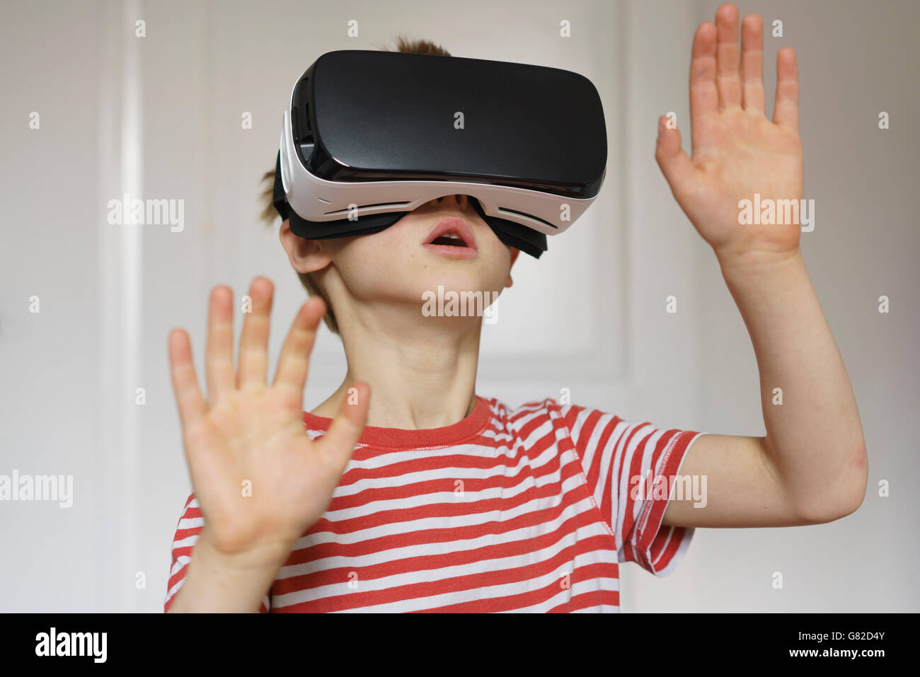 Boy playing virtual reality game at home Stock Photo
