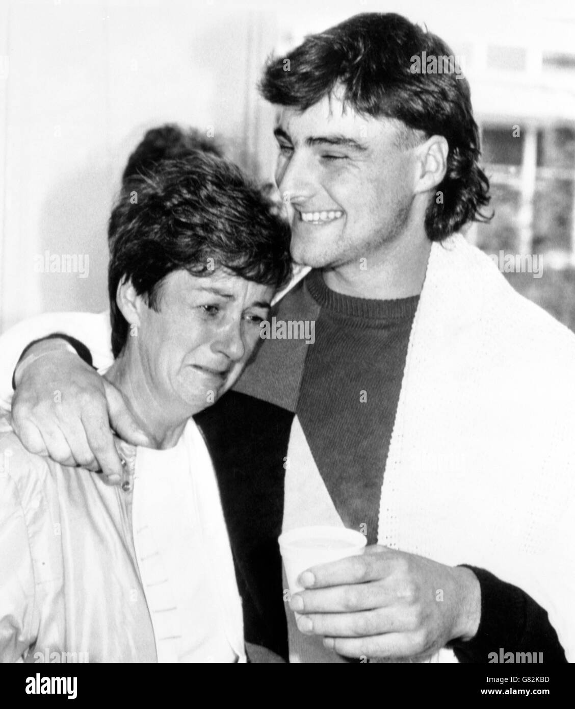 Tears of relief from Mrs Christine Tatlock and an arm of comfort from her son Mark, 19, when she arrived at Wythenshawe Hospital to find he survived the British Airtours Boeing 737 crash at Manchester Airport. Stock Photo