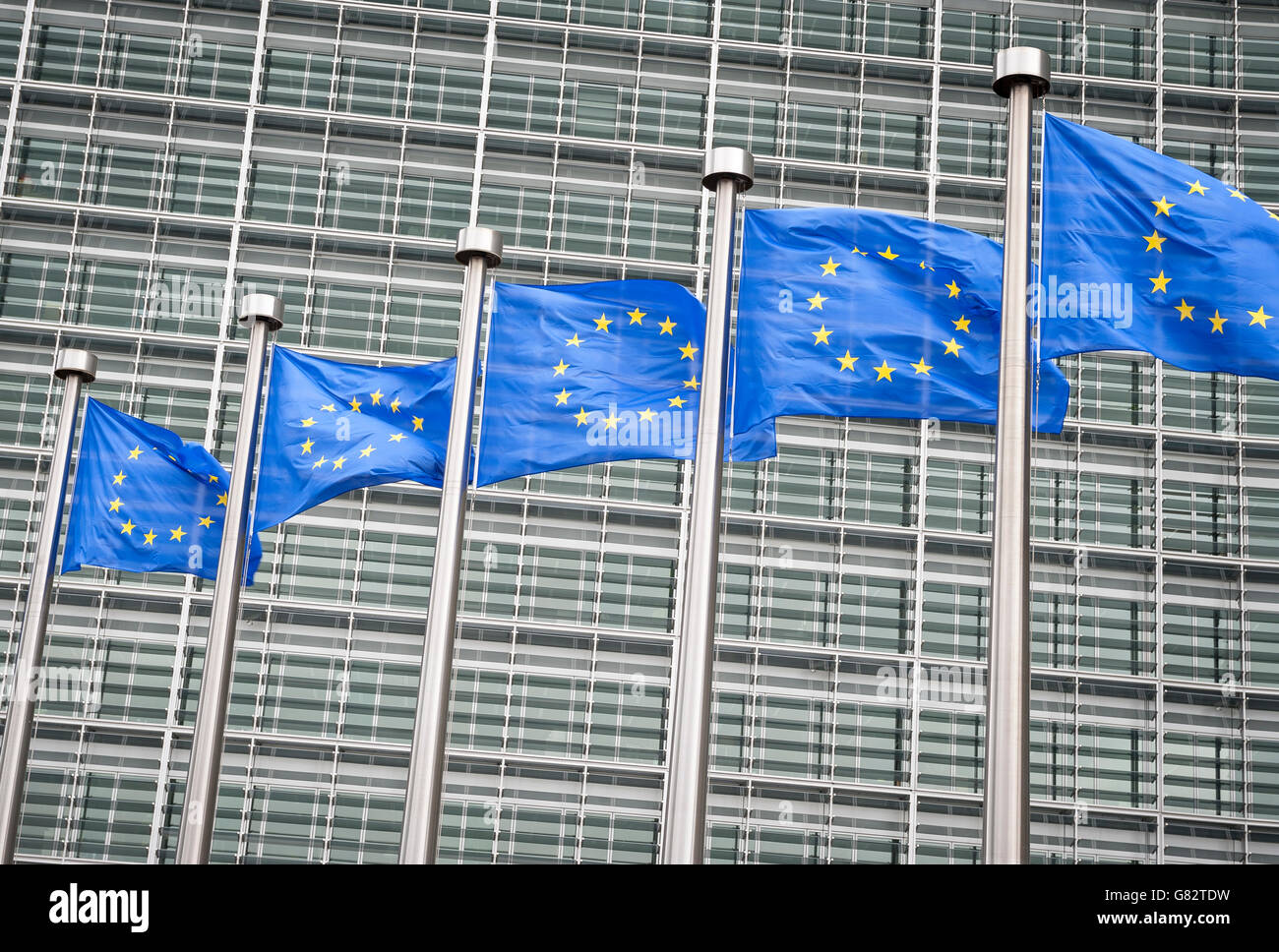 Row of EU European Union flags flying in front of administrative building at the EU headquarters in Brussels, Belgium Stock Photo
