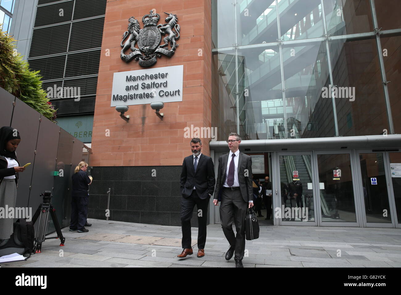 Ex-Manchester United footballer Roy Keane (centre left) leaves Manchester Magistrates' Court after he was cleared of aggressively confronting a taxi driver in an alleged road rage row. Stock Photo