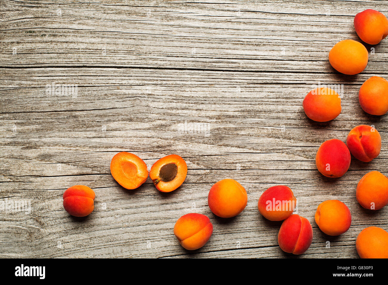 Fresh cut apricot fruits on wooden background Stock Photo