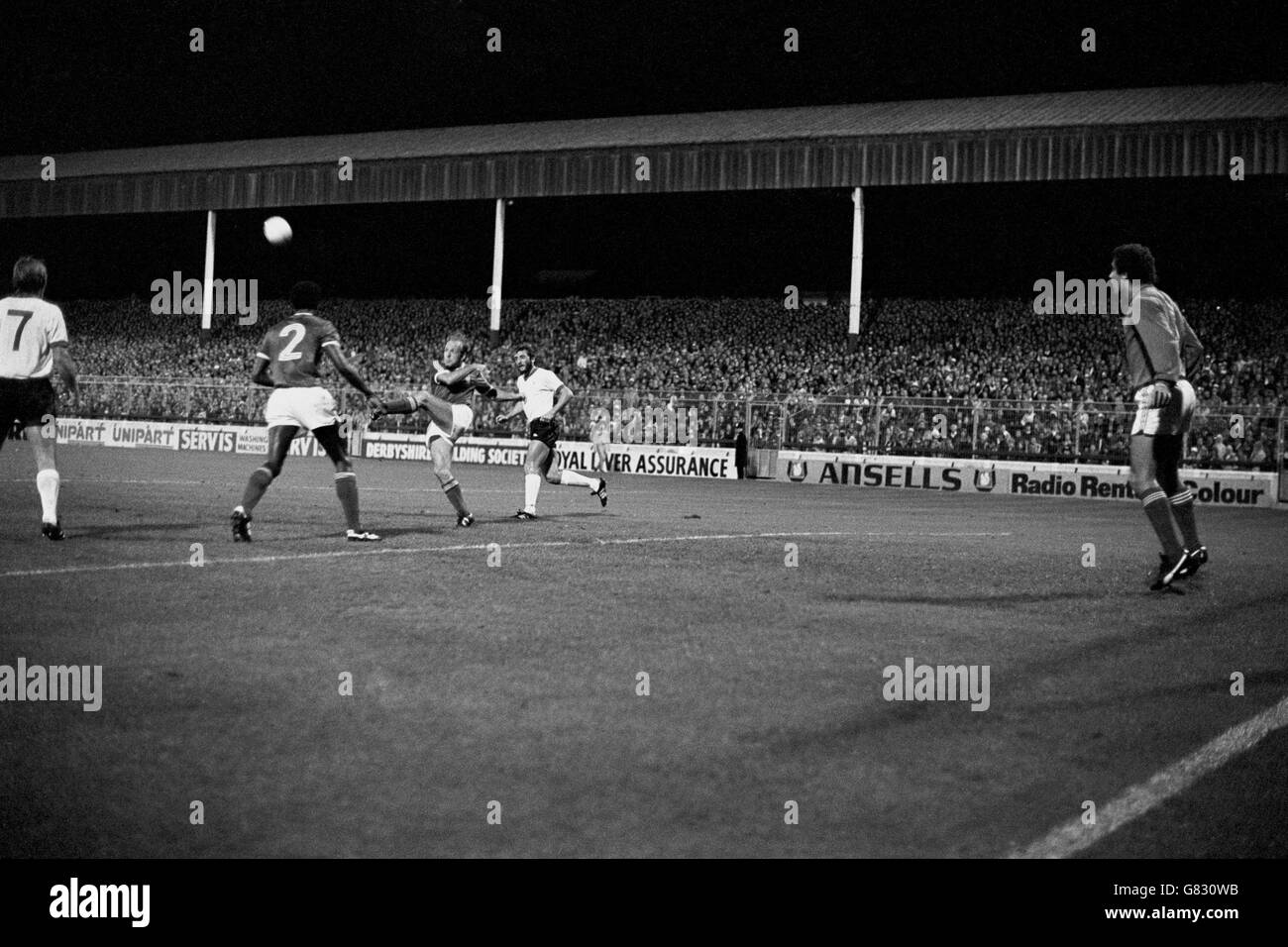 Nottingham Forest's Archie Gemmill (c) hacks the ball clear, watched by teammates Peter Shilton (r) and Viv Anderson (second l), and Liverpool's Kenny Dalglish (l) and Alan Kennedy (r) Stock Photo