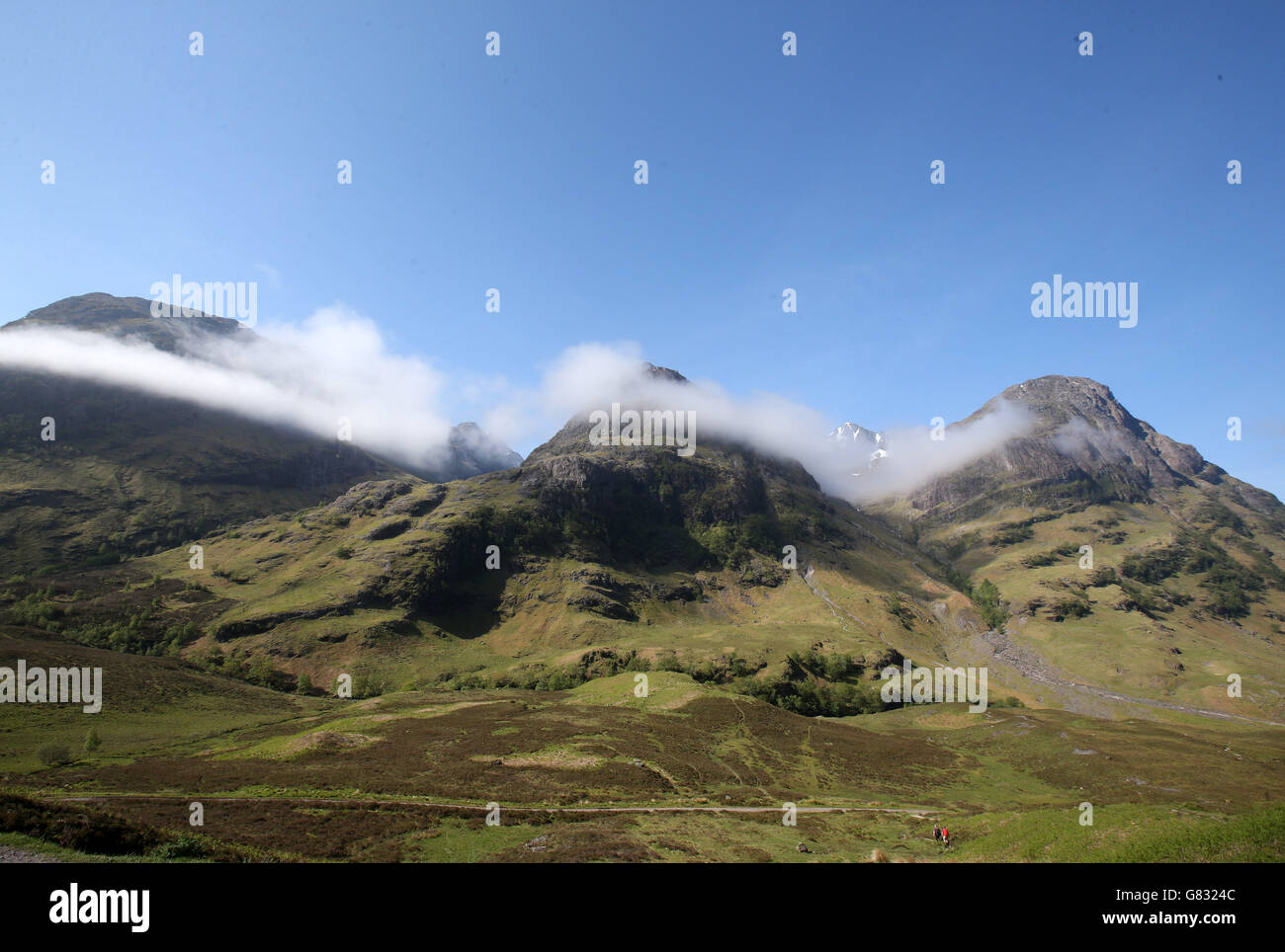 Hillwalkers set out towards the Three Sisters mountain range in Glencoe