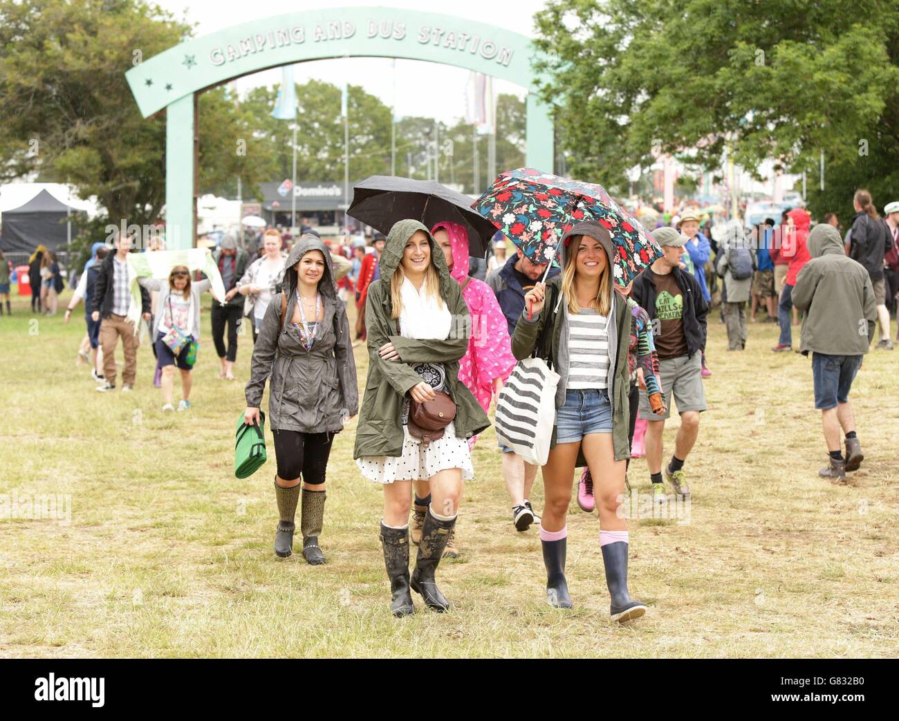 Festivalgoers during a rain shower at the Isle of Wight Festival, in  Seaclose Park, Newport, Isle of Wight Stock Photo - Alamy