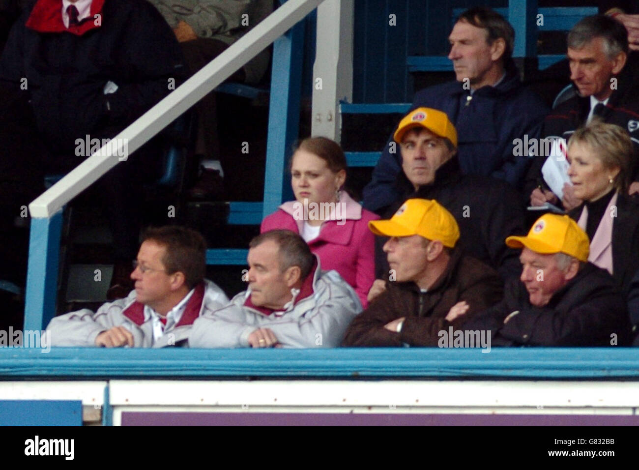 Charlton athletic directors wearing yellow caps in the directors box hi