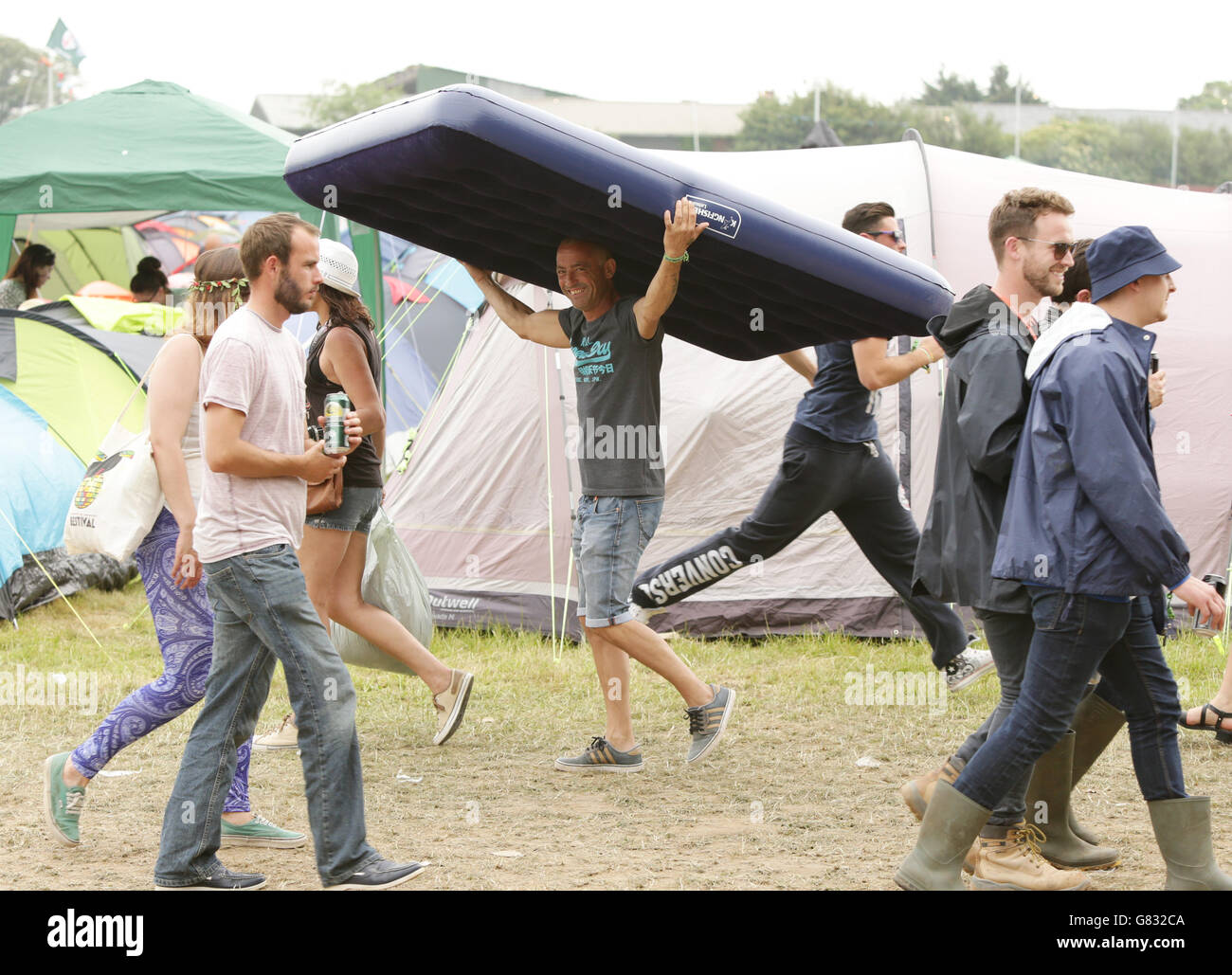 A festivalgoer carrying an inflatable mattress at the Isle of Wight