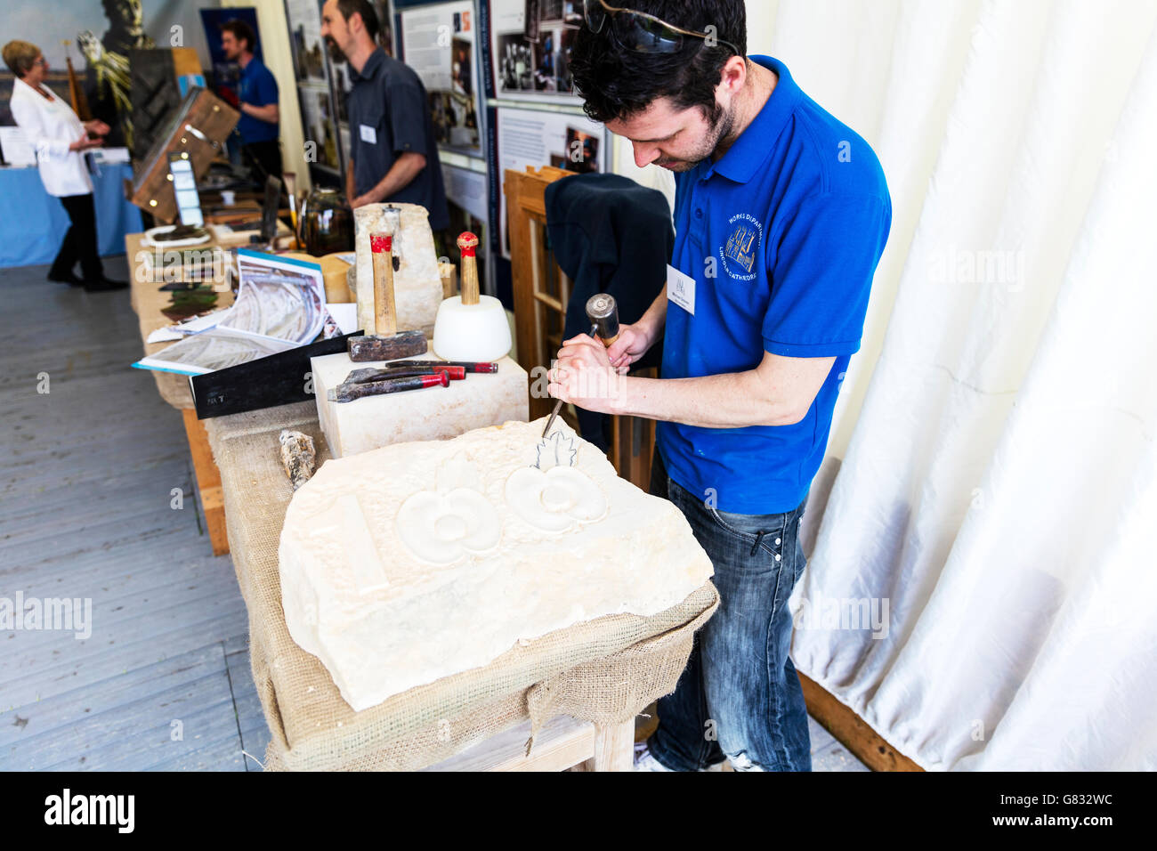 Stonemason carving stone stone mason working using hammer and chisel hi