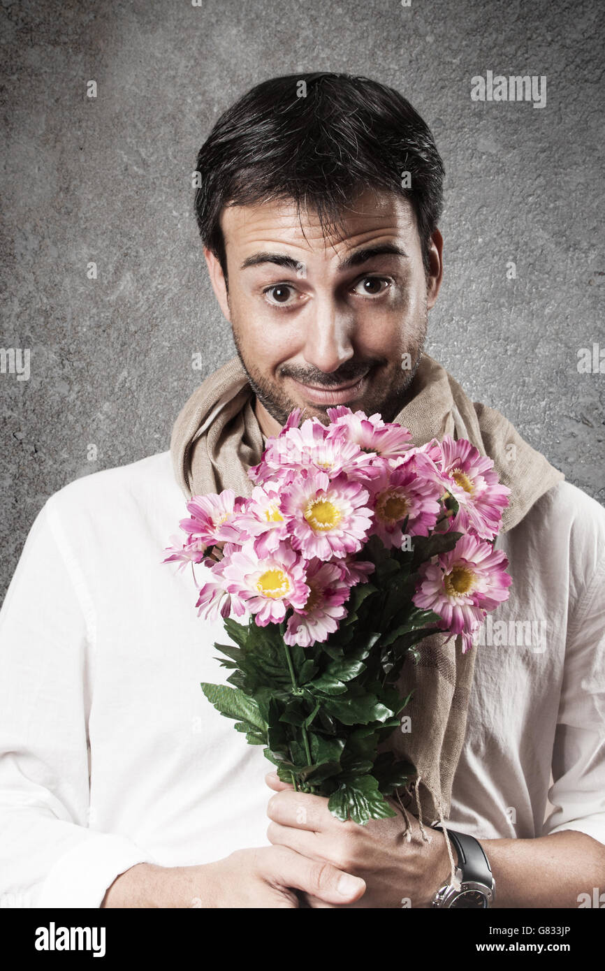 Man in love with a bouquet of flowers. Vertical image. Stock Photo