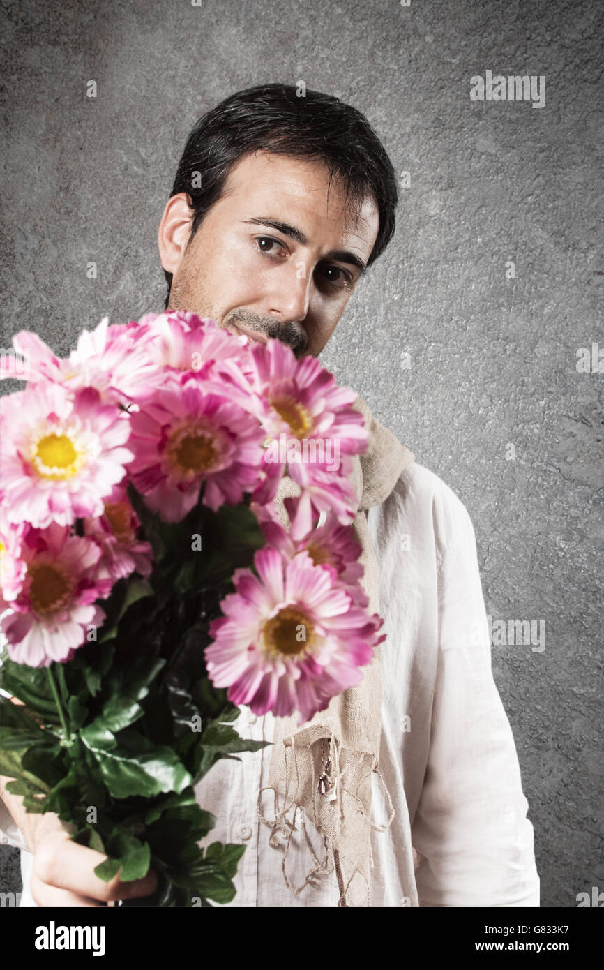 Man in love with a bouquet of pink flowers. Vertical image. Stock Photo