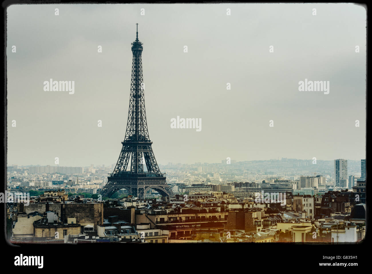 The Eiffel Tower in Paris, France. Vintage look with film grain, darkroom style frame, and light leak. Stock Photo