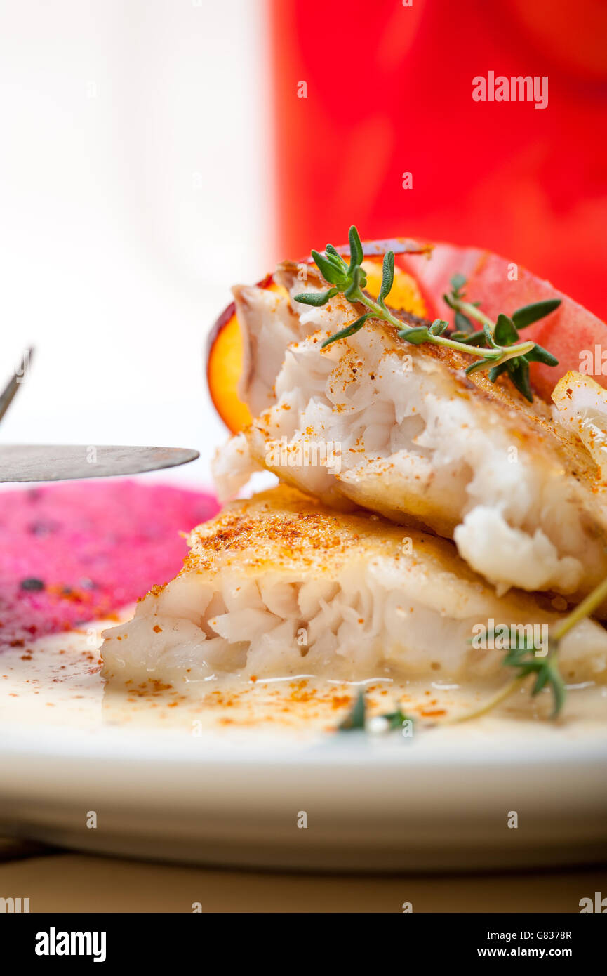 sea bream orata  fillet butter pan fried with fresh peach prune and dragonfruit slices thyme on top Stock Photo