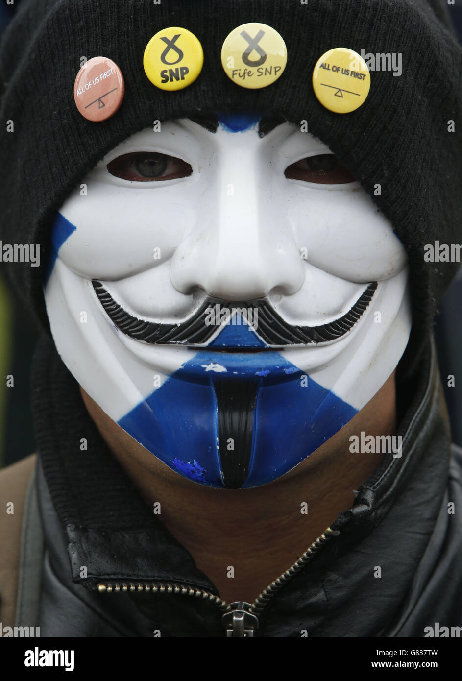 Anti-austerity protest. A protester wearing a mask at the Scotland United Against Austerity rally held in George Square, Glasgow. Stock Photo