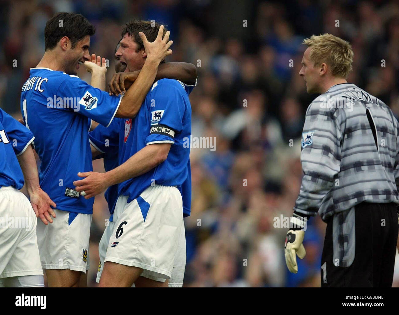 Portsmouth's Arjan de Zeeuw (C) celebrates scoring with Dejan Stefanovic as Southampton goalkeeper Antti Niemi looks on. Stock Photo