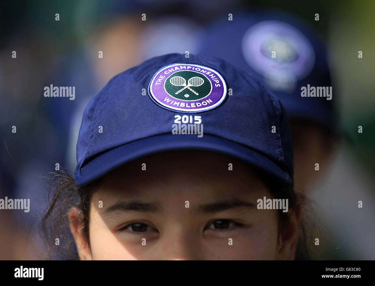 A ball girls sports a Wimbledon baseball cap during day one of the Wimbledon Championships at the All England Lawn Tennis and Croquet Club, Wimbledon. PRESS ASSOCIATION Photo. Picture date: Monday June 29, 2015. See PA Story TENNIS Wimbledon. Photo credit should read Jonathan Brady/PA Wire. Stock Photo