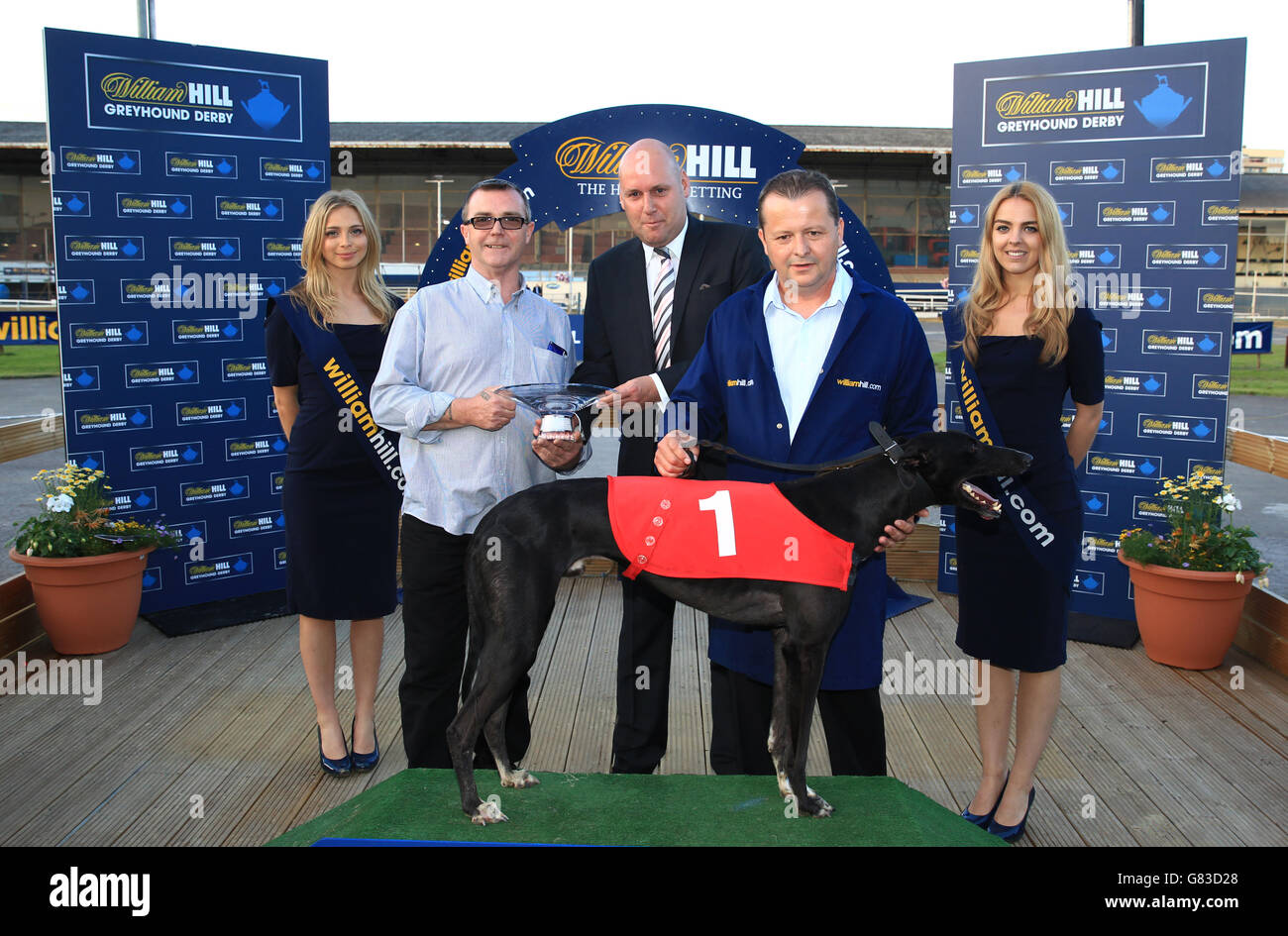 Trainer Steve Gammon (centre) with dog Jetstream Reason after victory in William Hill Champion Hurdle Final Stock Photo