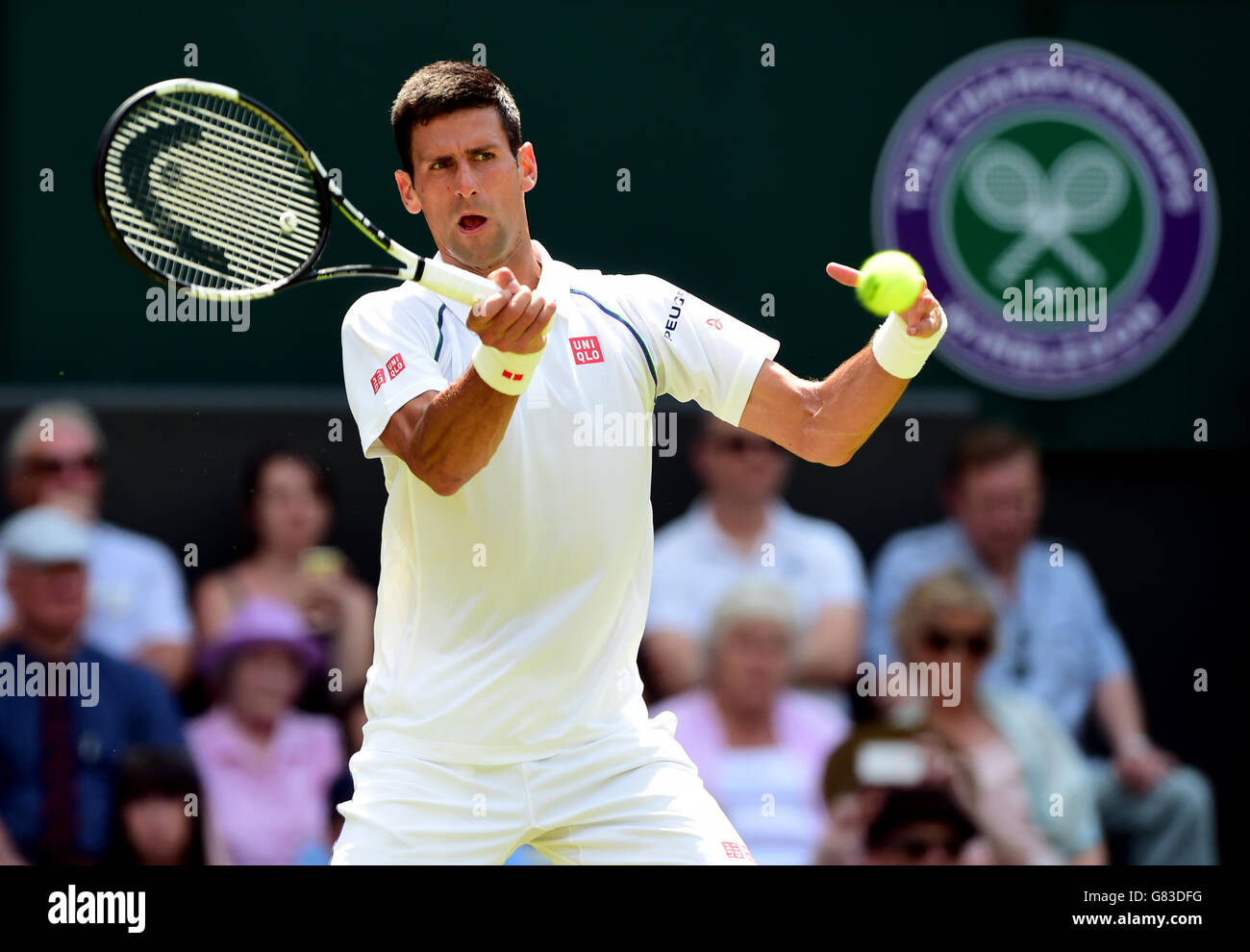 Novak Djokovic in action against Jarkko Nieminen during day Three of the Wimbledon Championships at the All England Lawn Tennis and Croquet Club, Wimbledon. Stock Photo