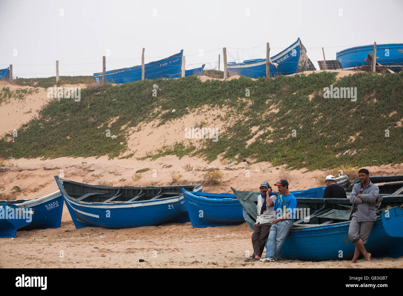 Fishing boats ashore in Tifnit beach near Agadir, Morocco. Stock Photo