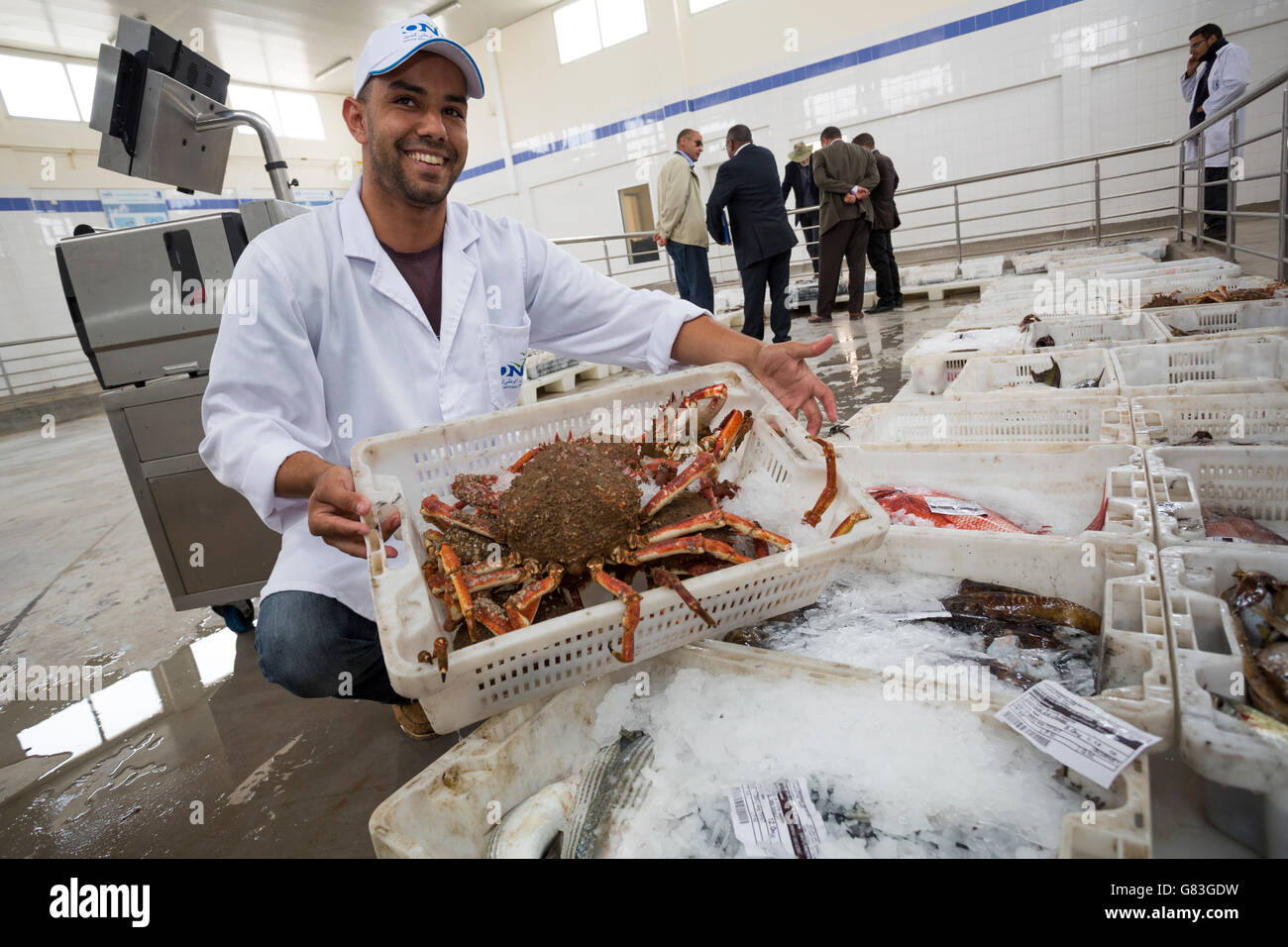 Workers buy and sell fresh seafood and fish at auction in Tifnit, near Agadir, in Morocco Stock