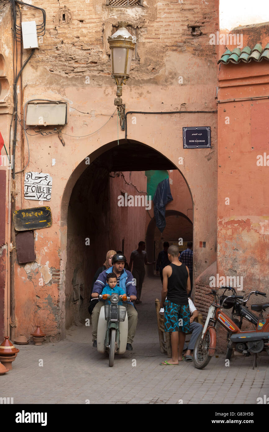 Local residents and tourists dash through the narrow streets of the Marrakesh Medina, Morocco. Stock Photo