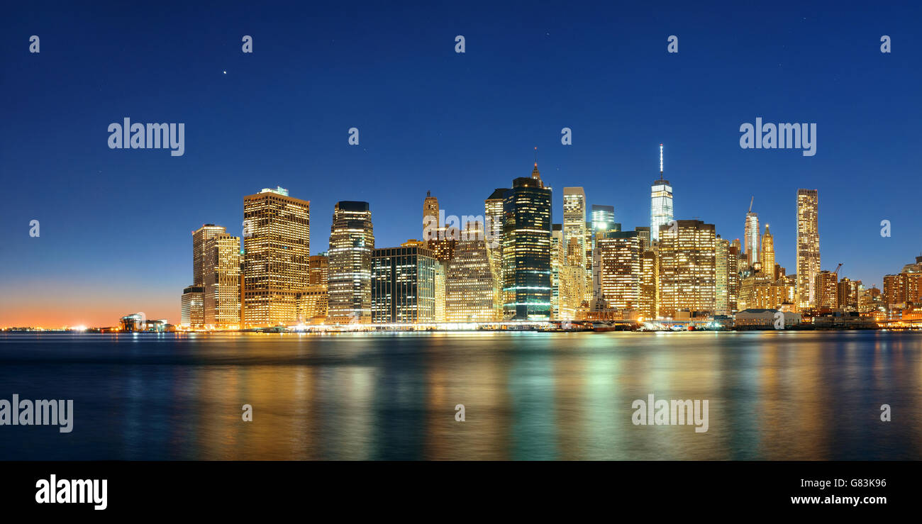 Downtown Manhattan skyline over East River at night in New York City ...