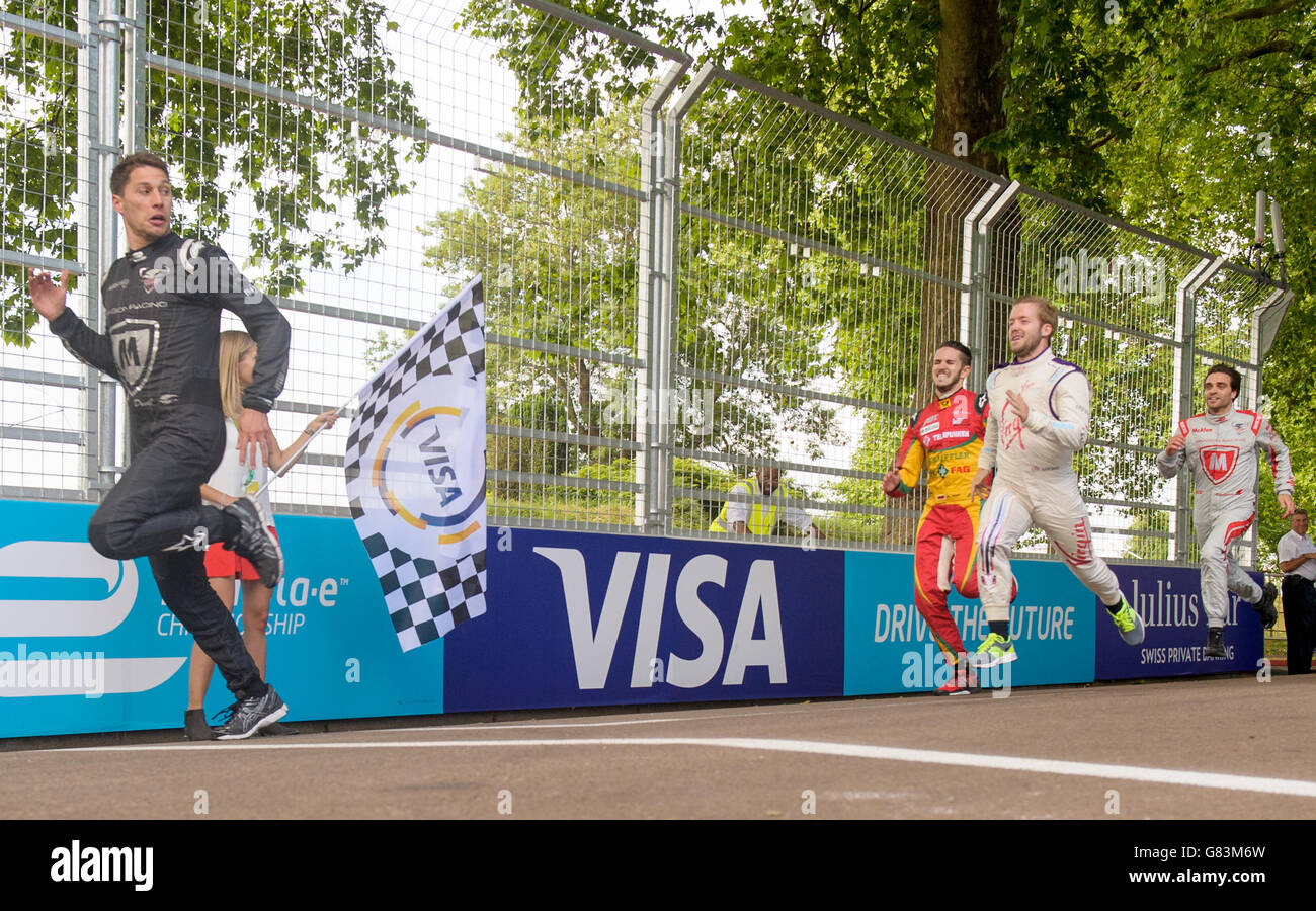 Formula E drivers race each other in a challenge laid down by the Visa innovation ambassador Usain Bolt ahead of the Visa London E-prix in Battersea, London. Stock Photo