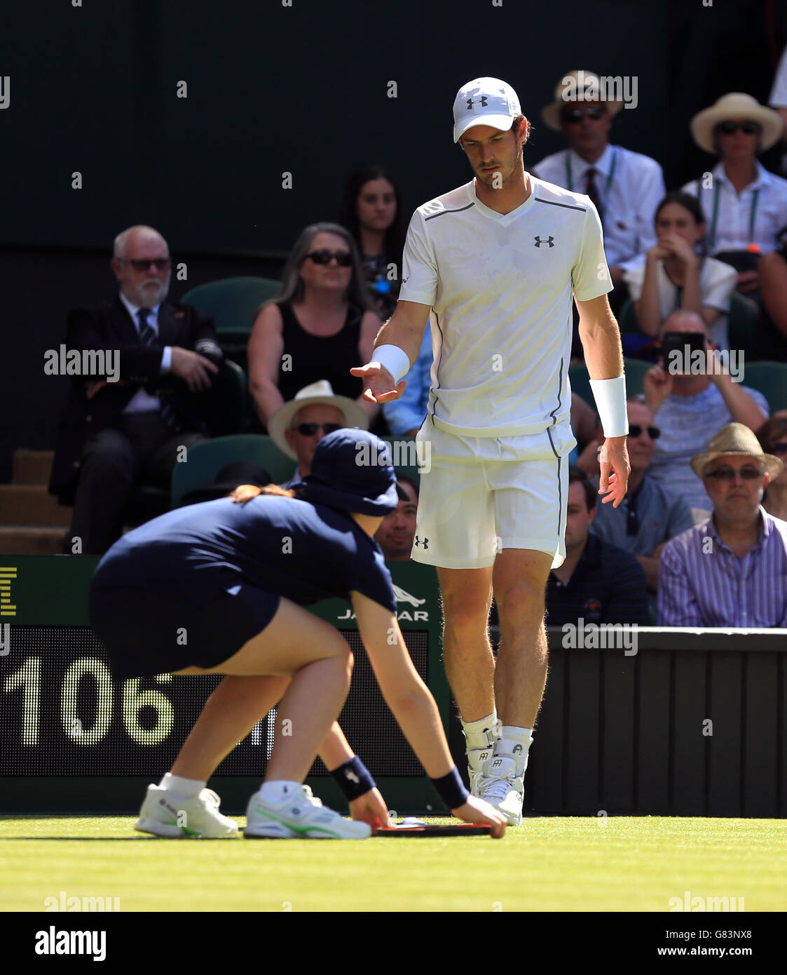 Andy Murray retrieves his racket from ball girls during day two of the Wimbledon Championships at the All England Lawn Tennis and Croquet Club, Wimbledon. Stock Photo