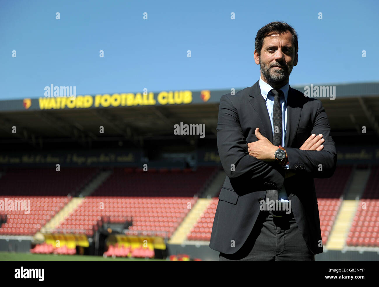 Watford's new head coach Quique Sanchez Flores poses for photographs pitch side after a press conference at Vicarage Road, Watford. Stock Photo