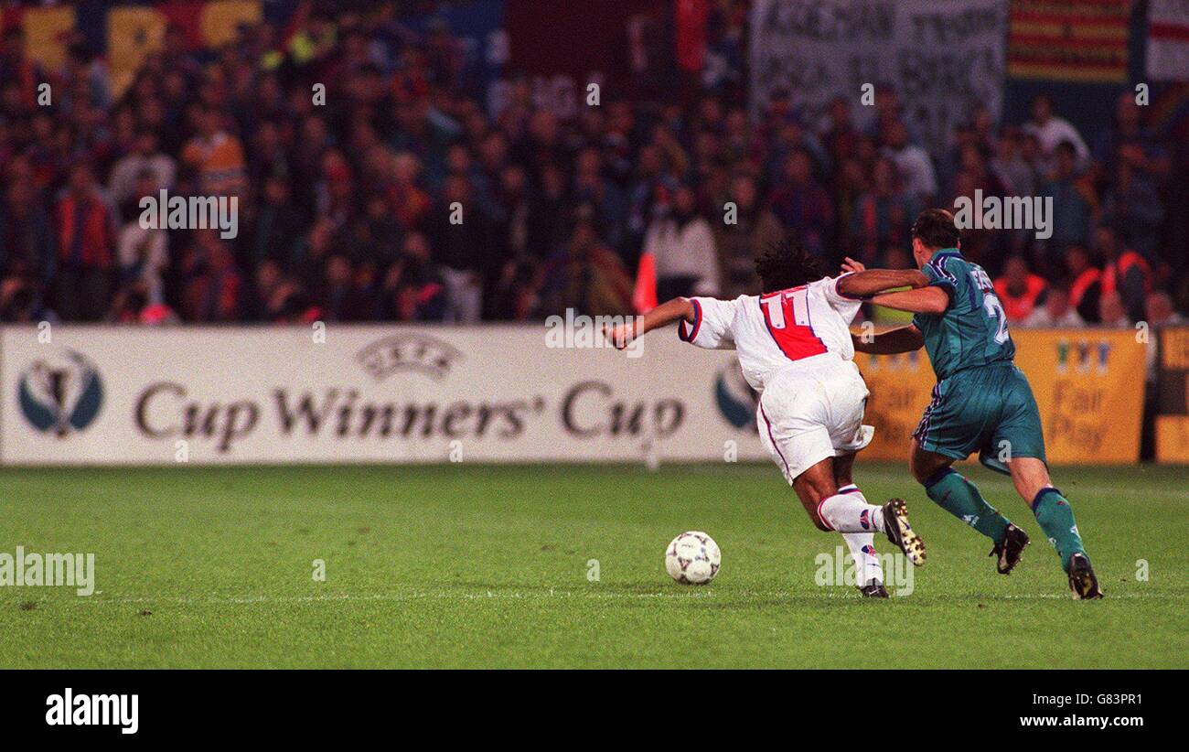Soccer ... UEFA Cup Winners Cup Final ... Barcelona v Paris St Germain. Patrice Loko, Paris St Germain battles with Albert Ferrer, Barcelona in front of a UEFA Cup Winners Cup sign Stock Photo