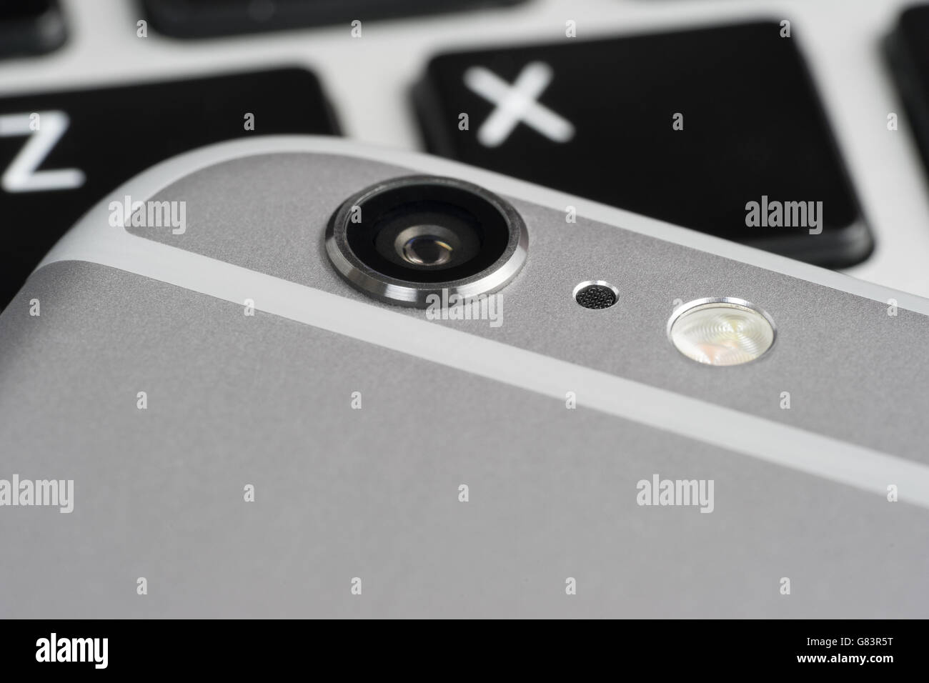 Closeup camera phone, on the laptop keyboard Stock Photo Alamy