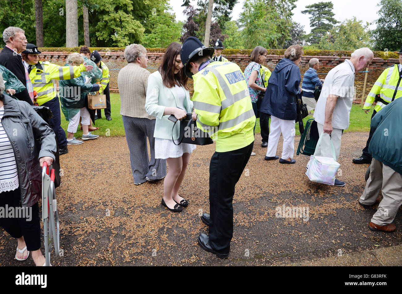 A large crowd of loyal royal fans pass through security to the area around the Church of St Mary Magdalene in Sandringham, Norfolk, as Princess Charlotte will be christened in front of the Queen and close family. Stock Photo