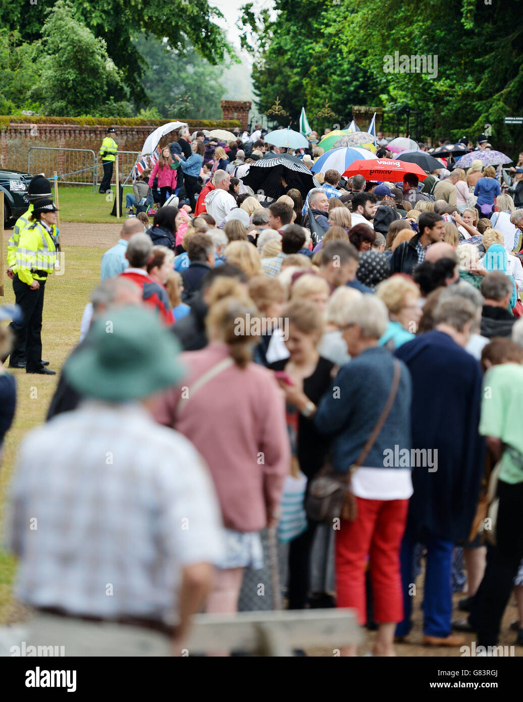 A large crowd of loyal royal fans near the area around the Church of St Mary Magdalene in Sandringham, Norfolk, as Princess Charlotte will be christened in front of the Queen and close family. Stock Photo