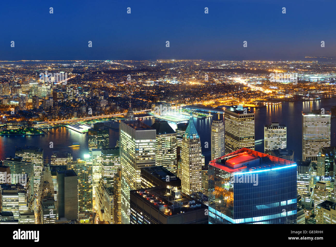 Rooftop night view of New York City downtown with urban skyscrapers ...