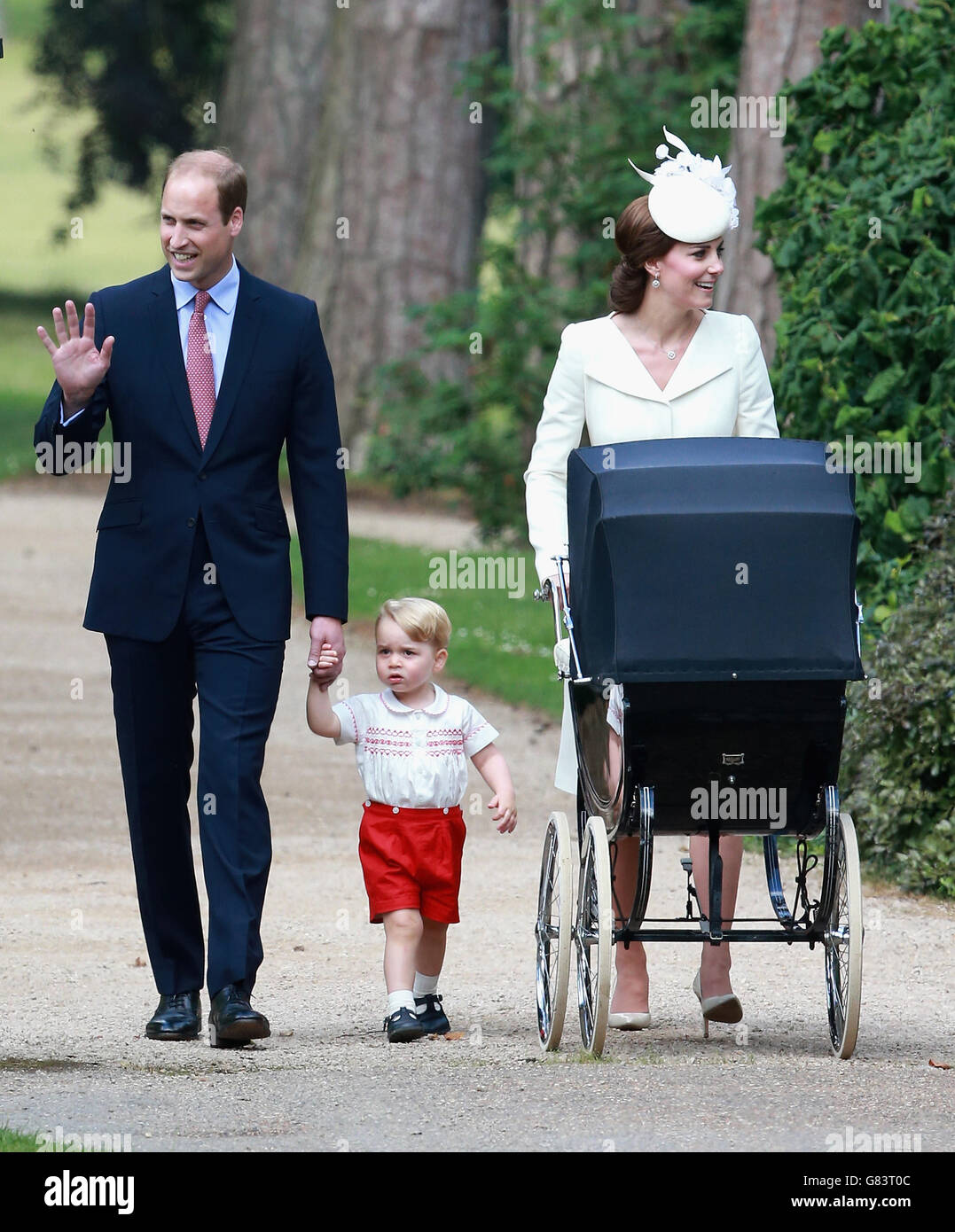 The Duke and Duchess of Cambridge with Prince George and Princess Charlotte pushed to her christening in a vintage pram the Queen used for two of her own children as they arrive