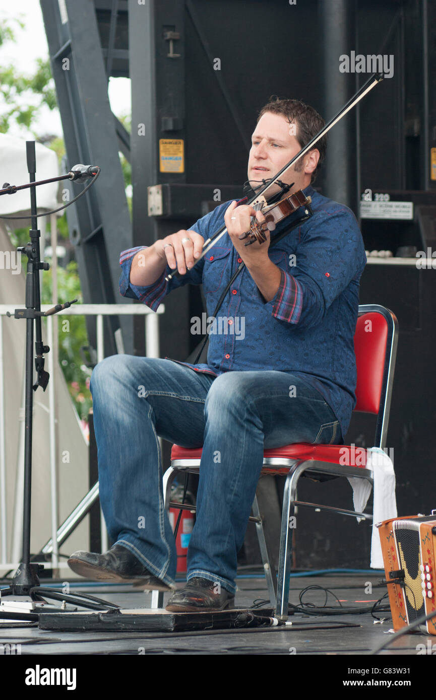 Andre Brunet, Quebecois musician playing the fiddle/foot tapping, De Temps Antan performing at the 2015 American Folk Festival Stock Photo