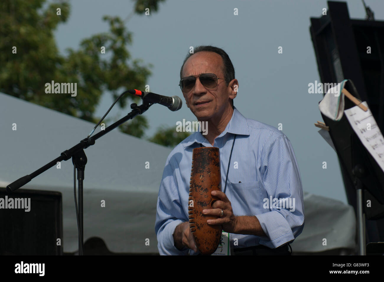 Vocalist Jorge Maldonado playing a Guiro for Mitch Frohman & The Bronx Horns, a Mambo Orchestra Stock Photo