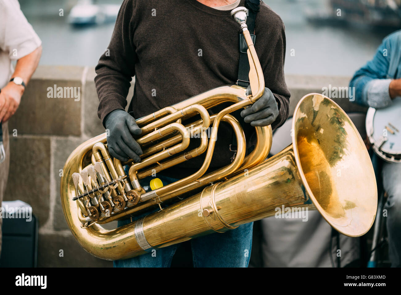 Street Busker performing jazz songs outdoors. Close up of big tube Stock Photo